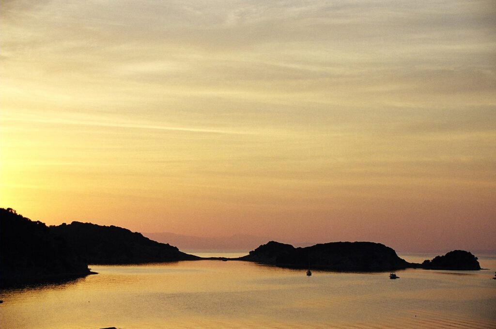 orange sunset of a near-by island from the shore